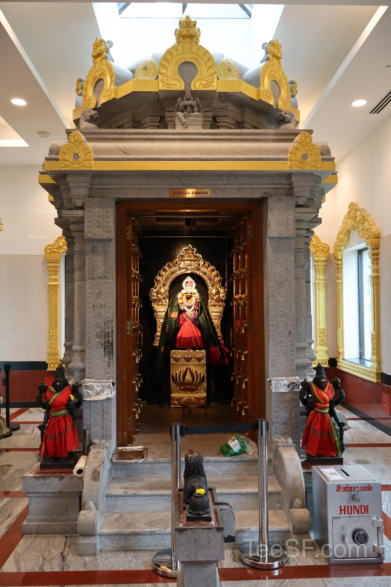 A small deity shrine centered in a quiet temple alcove.